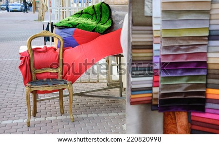 Colorful upholstery samples and wooden frame of  antique armchair near the entry to the workshop. Beersheba, Israel. Selective focus on the chair.