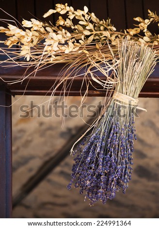 Hanging bouquet of dry lavender. Rustic decoration of old farm house in Provence (France).