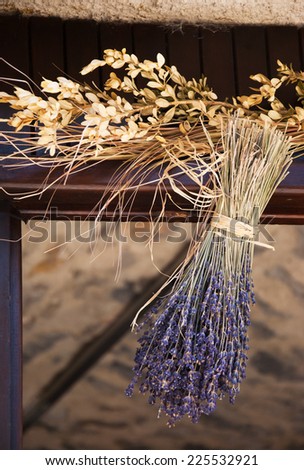 Hanging bouquet of dry lavender. Rustic decoration of old farm house in Provence (France).