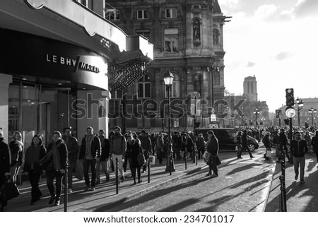 PARIS, FRANCE - NOVEMBER 30, 2013: Shopping crowd near BHV department store located across Hotel de Ville (City Hall). Christmas shopping in Paris starts already in November.