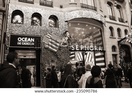 PARIS, FRANCE - NOVEMBER 22, 2014: SEPHORA store decorated for Christmas holidays at Avenue des Champs-Elysees and shopping crowd. This French cosmetics and perfume chain was founded at 1970 in Paris.