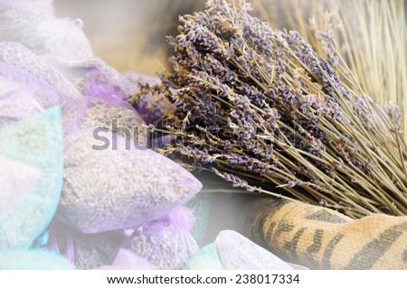 Dried lavender for sale in transparent  bags. Selective focus on dried flowers bunch over the rough  bag.