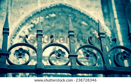 Forging fence of Cathedral in Chartres (France). Aged photo. Selective focus on the arrows of the fence.
