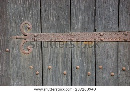 An old castle gate with rusty door hinge.