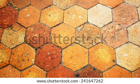 Old terracotta tile floor. Honeycomb pattern.