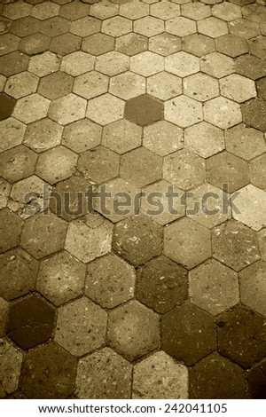 Old terracotta tile floor. Honeycomb pattern. Aged photo. Sepia.