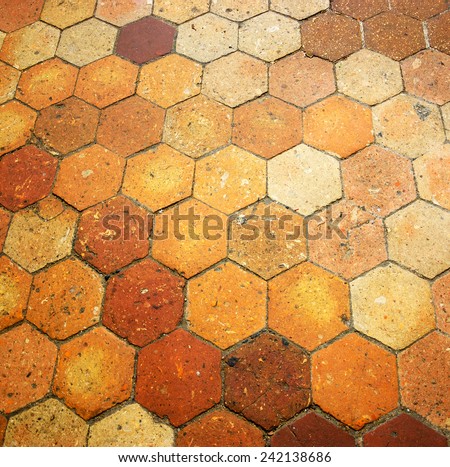 Old terracotta tile floor. Honeycomb pattern.