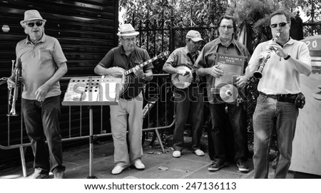 PARIS, FRANCE - AUGUST 15, 2013: Five unidentified musicians play jazz near Church of Saint-Germain-des-Pres. Dozens buskers perform on the streets and in the metro of Paris.