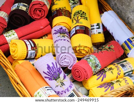 LES BAUX-DE-PROVENCE, FRANCE - MAY 16, 2013: Colorful kitchen towels with lavender flower embroidery and inscription PROVENCE are sold in souvenir shop. Lavender known as one of Provence\'s symbols.