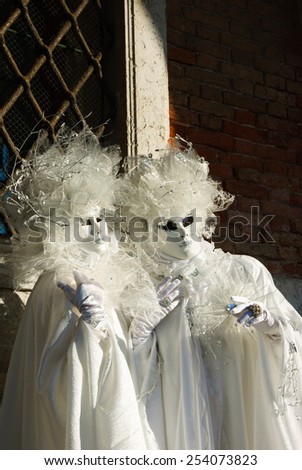 VENICE, ITALY - FEBRUARY 16, 2015:Two Pierrot masks in St Mark\'s Square square during the traditional Carnival. The Carnival in Venice is annual event which ends on Shrove Tuesday.