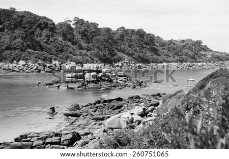 Pink Granite Coast near Trebeurden (Brittany, France). Aged photo. Black and white.
