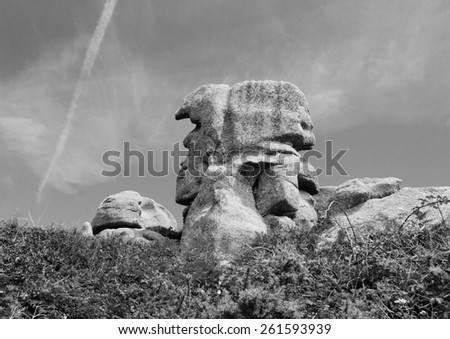 Pere Trebeurden (Father Trebeurden)  - granite rock in shape of male head at Pink Granite Coast near Trebeurden (Brittany, France). Aged photo. Black and white.