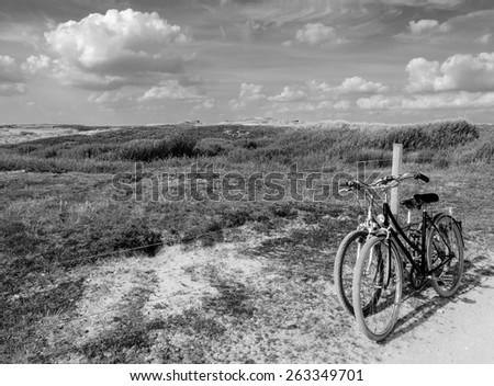Two bicycles in countryside. Brittany, France. The concept of romance, love and simple everyday life. Aged photo. Black and white.