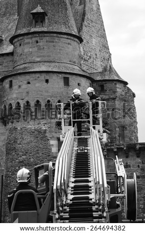 VITRE, FRANCE - JULY 12, 2014: Firemen carry out training exercise near the castle of Vitre. The castle of Vitre was built in 11th century and rebuilt at 13th century.