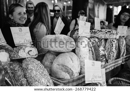 LONDON, ENGLAND, UK - MAY 3, 2014: Unidentified young people purchase bread at Karaway bakery in famous Borough Market. In last decades Borough Food Market became a fancy tourist attraction.