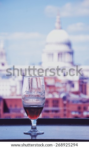 A glass of beer and a view from Tate Modern gallery\'s cafe on St Paul Cathedral. London, England. Toned photo.