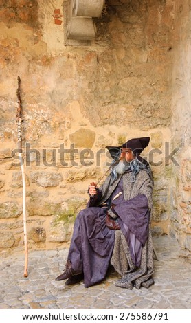 OBIDOS, PORTUGAL - APRIL 30, 2015: Unidentified senior actor performs as Gandalf from The Lord of the Rings entertaining the tourists at the gate of medieval town of Obidos.