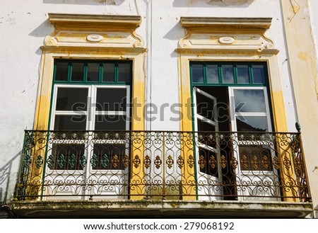 Balcony with wrought iron railing. Old typical house in Evora, Portugal. Historic Centre of Evora is a UNESCO World Heritage Site.