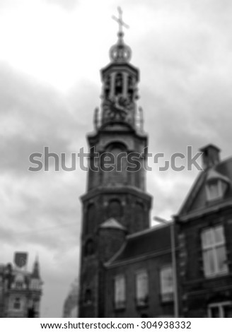 Munttoren clock tower in Amsterdam.  Blurred aged photo. Black and white.