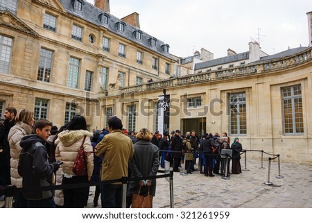 PARIS, FRANCE - JANUARY 4, 2015: People stand in queue at the entrance to Pablo Picasso museum. National museums propose free entrance to their collections on first Sunday of every month.