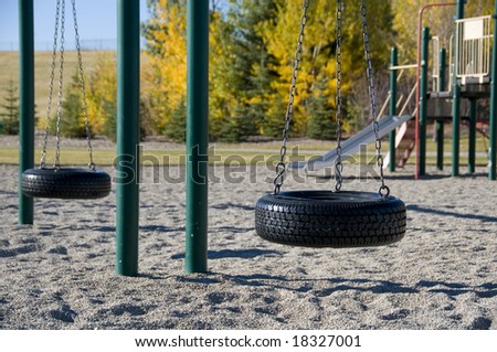 empty tire swing set in fall