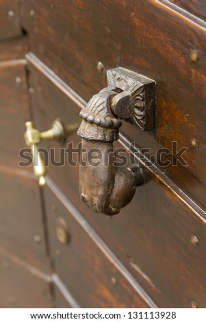 Vintage door knocker, shaped like a fist on an Italian door in the Emilia-Romagna region