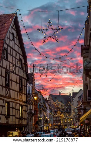 COLMAR, FRANCE - DECEMBER 7, 2013 - Christmas Star decoration in front of pink dusk clouds at the Christmas market on December 7, 2013 in Colmar.