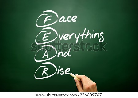 Hand drawn Face Everything And Rise (FEAR) acronym, business concept on blackboard