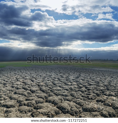 dramatic sky over drought earth