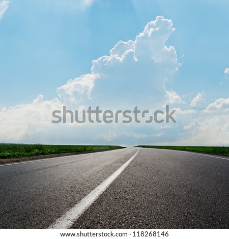 Asphalt Road To Horizon In Cloudy Sky