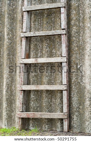 wooden ladder near old roofing slate