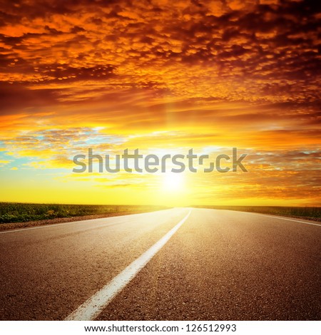 red dramatic sunset over asphalt road