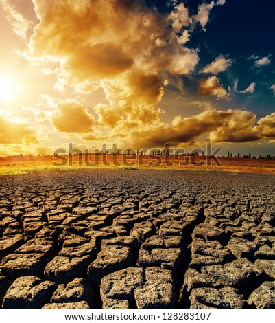 dramatic sunset over drought earth