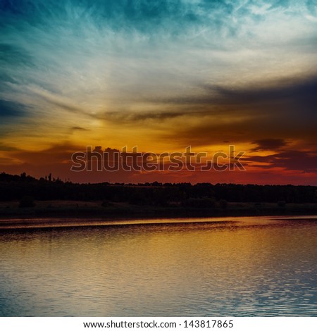 dark sunset over dark water