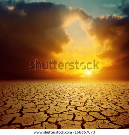Orange Cloudy Sunset Over Cracked Desert