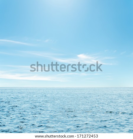 Blue Sea And Clouds In Sky Over It