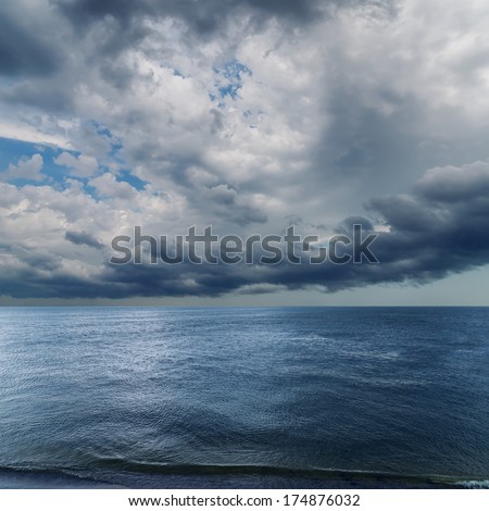 dramatic sky over darken sea. rain before