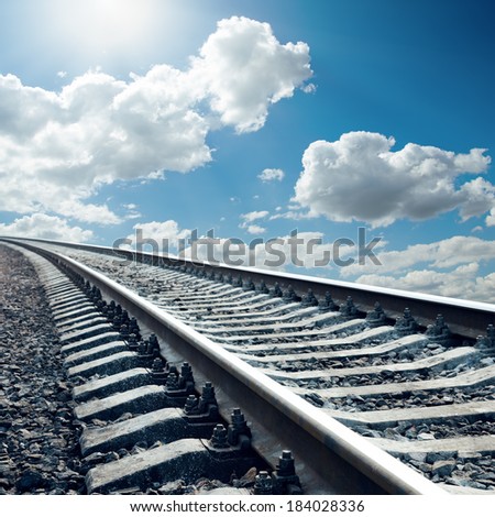 railroad closeup to horizon in sky with sun
