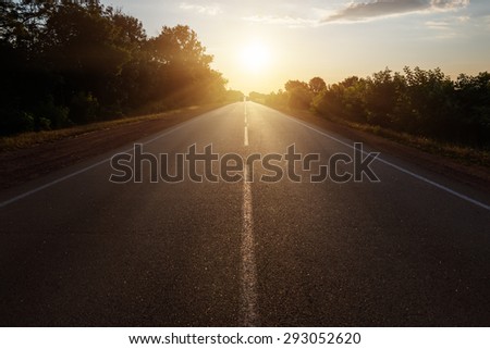 asphalt road to horizon in sunset