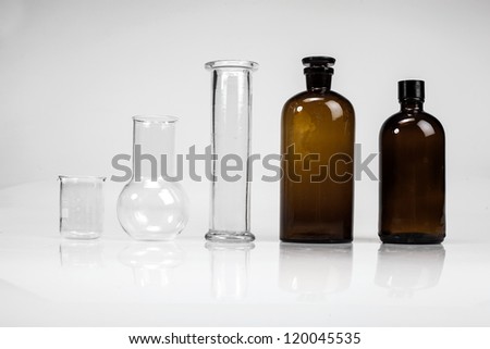 Pharmacy bottles and test-tubes on white background.
