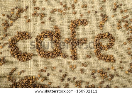 Word cafe made with coffee beans on burlap.