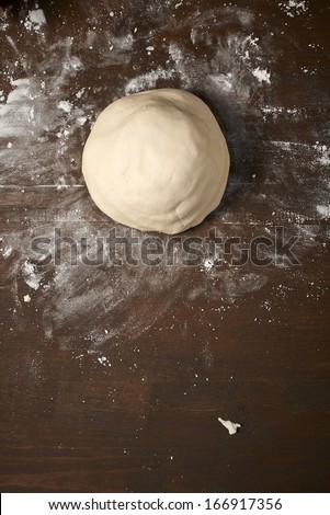 knead dough on wooden table, is ready