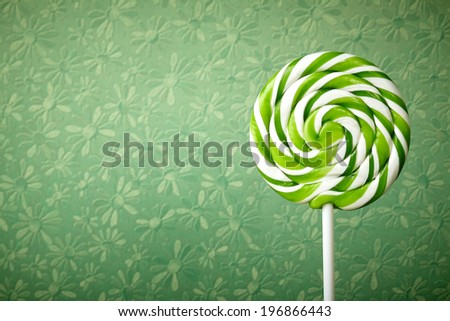 green and white large spiral lollipop on stick