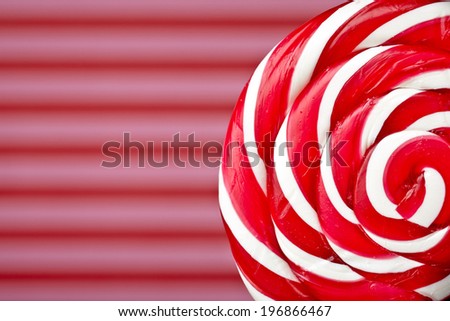 red and white large spiral lollipop on stick