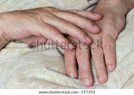 Wrinkled hands of old man in repose