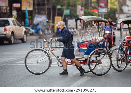 Tricycle bicycle taxi cruising the streets for customers on February 28, 2015 in Chiang Mai,Thailand. Tricycle bicycle taxi is one of the public transport in Thailand.