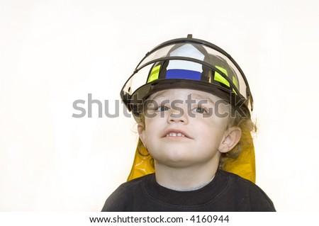 Young boy wearing black firefighter helmet with visor