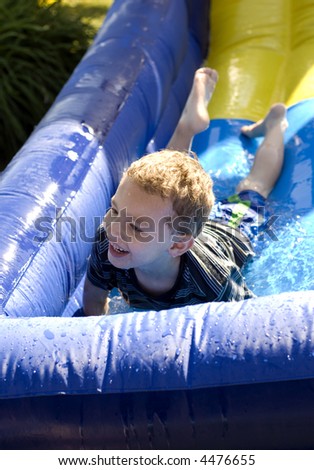 Young boy at bottom of water side laughing