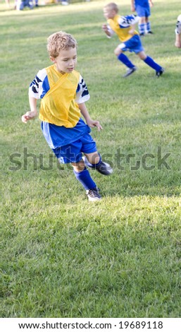 soccer player positions. stock photo : Young soccer player getting in position to steal ball on field