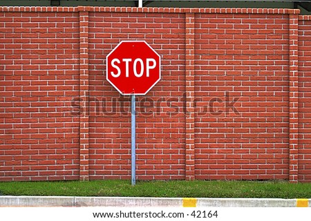Stop sign against a brick wall. This would be the last stop sign you run.